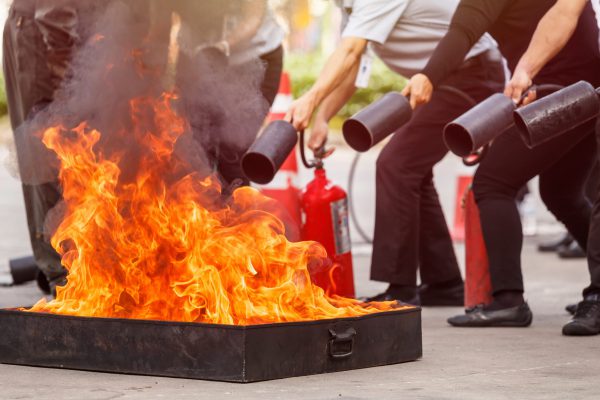 Thai people in the conflagration preventive extinguisher training program, Safety concept. Focus on fire tray